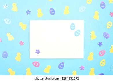 Empty card with spring, easter decoration over blue pastel backgroung with copy space