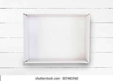 Empty Cardboard Box On White Wooden Background