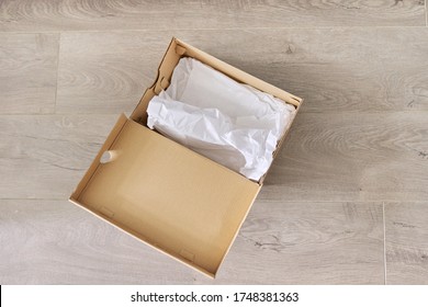 Empty Cardboard Box From Shoes On The Floor In The House, Top View.