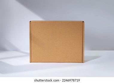 Empty cardboard Box with window shadow - Shutterstock ID 2246978719