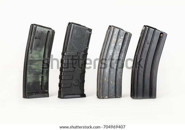 Empty cardrige\
for gun. 20 caliber handgun magazine on white loaded with hollow\
point cartridges. Gun\
magazines.