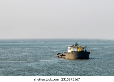 Empty Cargo ship container moving on the waters of the sea.