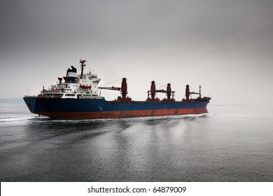 The empty cargoship going through passage Dardanelless, Turkey, in rainy weather