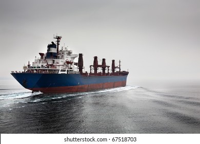 The empty cargoship going through passage Dardanelless, Turkey, in rainy weather