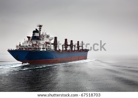 The empty cargoship going through passage Dardanelless, Turkey, in rainy weather