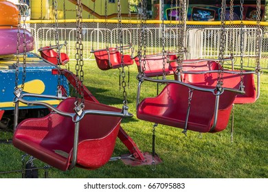 Empty Carnival Ride Children's Red Chairs