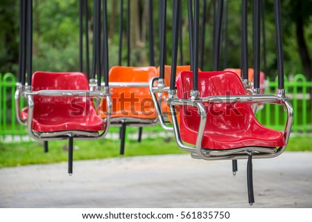 Empty Carousel flying swing ride attraction with colorful swinging chairs