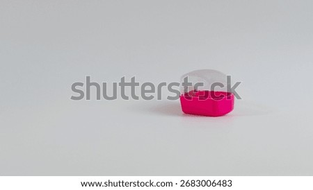 An empty case for any small device such as a digital tally counter or finger watch ring, in fuchsia on white background