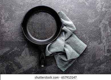 Empty Cast Iron Frying Pan On Dark Grey Culinary Background, View From Above