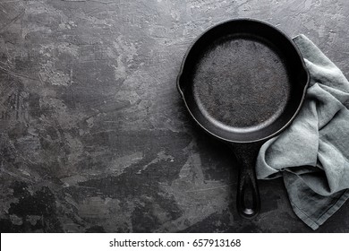 Empty Cast Iron Frying Pan On Dark Grey Culinary Background, View From Above