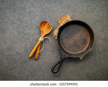 Empty Cast Iron Skillet Frying Pan Flat Lay On Dark Stone Background With Copy Space .