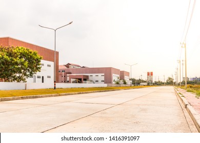 Empty Cement Road In Industrial Park Before Sunset