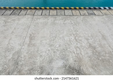 Empty cement square and blue lake water natural background. high angle view.