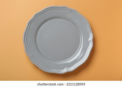 Empty Ceramic Plate On Pale Orange Background, Top View