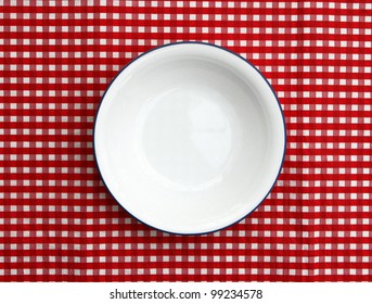 Empty Cereal Bowl Isolated On Red And White Checkered Background