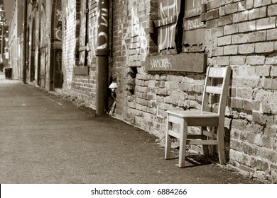 An empty chair in Brooklyn and a wall of graffiti, New York City