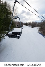 Empty Chair Lift Above Snowy Mountain Ski Slope 