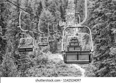 Empty Chair Lift In A Mountain Summer Scenario.