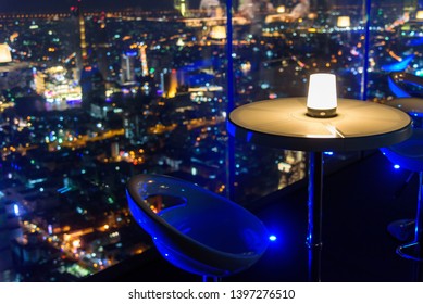 Empty Chair With Lighting At Rooftop Bar On High Building