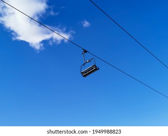 Empty Chairlift With A Blue Sky