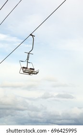 Empty Chairlift With Blue Sky In The Background