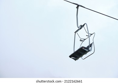 Empty Chairlift With A Cloudy Sky Background