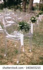 Empty Chairs With Floral Decorations Ready For Outdoor Wedding Ceremony   