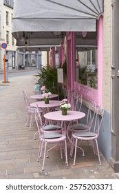  Empty chairs in front of a street cafe in the old town of Bruges in Belgium                              