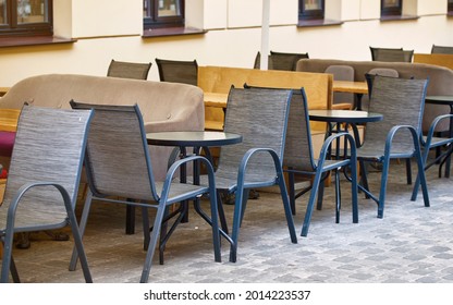 Empty Chairs And Tables In Restaurant During Pandemic, No People. Summer Terrace Restaurant In City Center. Summer Outdoor Cafe. Tables And Chairs, Summer Cafe