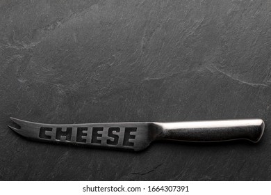 Empty Cheese Board With Knife. Copy Space. On Blackboard. Top View.