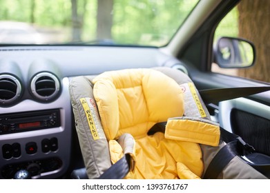 Empty Child Safety Seat In Car Mounted In The Front Seat