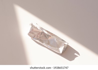 An Empty Chocolate Bar Wrapper On A White Background.