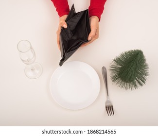 Empty Christmas Wallet. A Woman Is Holding A Purse With No Money On An Empty Holiday Table. The Financial Crisis During The Holidays.