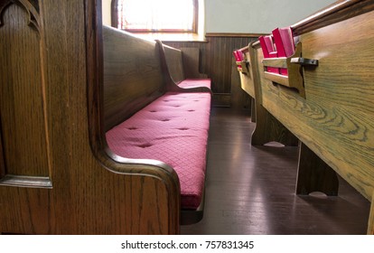 Empty Church Pew. Interior Of An Empty Church With Pew And Row Of Bibles.