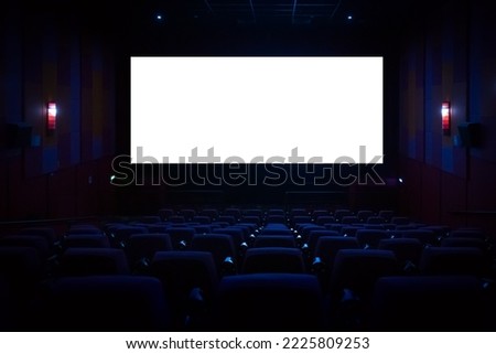 Empty cinema auditorium with empty white screen. Empty rows of theater or movie seats