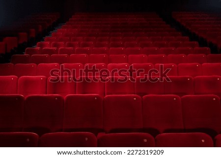 Empty cinema hall with red seats. Movie theatre, party hall.