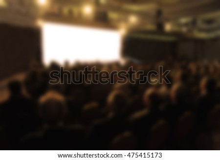 Empty cinema screen with audience. Ready for adding your picture. Blurred.