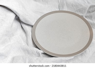 Empty Circle Plate On Table With Linen Napkin. Overhead View. Space For Text Or Menu . Business Food Brand Template.