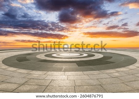 Empty circular floor and dramatic sky background at sunset