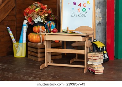 Empty Classroom With Blackboard And Wooden Table. Kindergarten. Interior Of Elementary School. Chalkboard, Backpack, Pencils And Stationery On Classroom. Teachers Day. Back To School. 