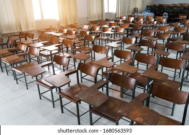 Empty classroom with a lot of chair with no student. Empty classroom with vintage tone wooden chairs. Back to school concept.