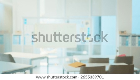 Empty classroom, desk and chairs for learning at college with lens flare, board and table in hall. Blurred room, campus and furniture at venue for scholarship, development and interior at university