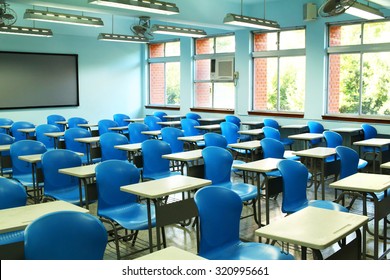 Empty Classroom With Desks And Chairs