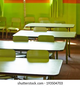 Empty Classroom In A Elementary School With Tables And Chairs