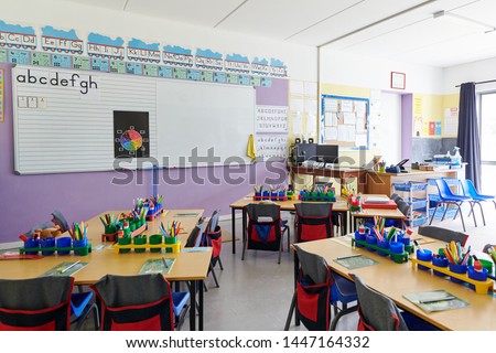 Empty Classroom In Elementary School With Whiteboard And Desks