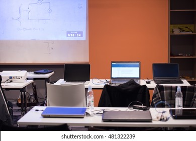 Empty It Classroom With Program Code On Projector Screen And Modern Laptop Computers On Table