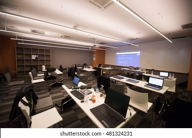 Empty It Classroom With Program Code On Projector Screen And Modern Laptop Computers On Table