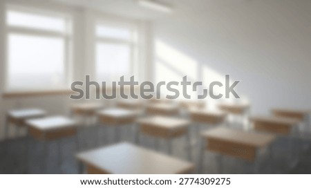 An empty classroom with rows of desks and large windows, all in a soft focus, creating a sense of calm and anticipation.