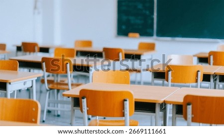 An empty classroom setting with rows of wooden desks and chairs, offering a serene and educational ambiance.