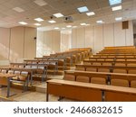 Empty classroom at the university. Audience at the university. Large empty auditorium. Lecture room. Many rows of desks.